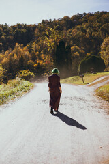 Young woman walking around on dirt road