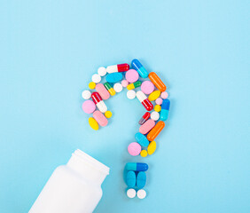 A question mark from laid out of medicine pills with bottle drug.