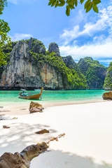 Thai traditional wooden longtail boat and beautiful beach in Thailand.