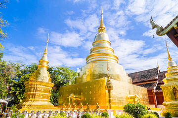 Naklejka premium Beautiful golden pagoda with blue sky at Wat Phra Singh, Thailand.