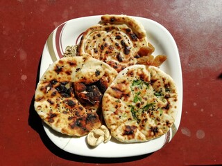 Indian traditional naan(bread) kept on a plate with red background 