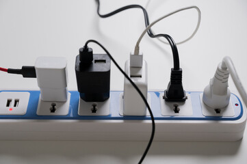 A lot of electric cable plugged in socket. Risk of electric shock Overload. Electrical equipment,...