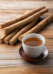 Burdock tea on a wooden board in the background