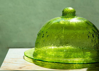 dome-shaped cover made of glass for keeping food away from flies on marble table