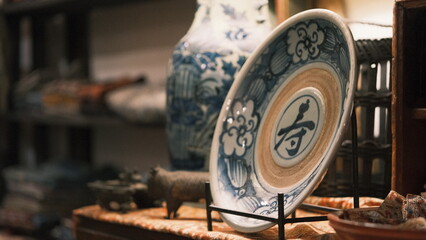 antique plate and lamp with ornate blue and yellow design