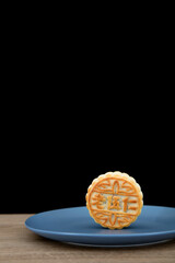On a blue plate is a moon cake for the Mid-Autumn Festival