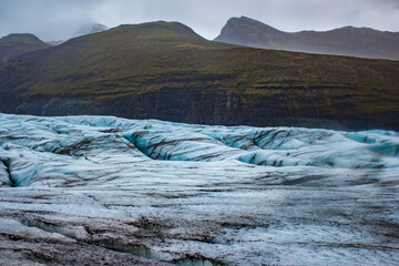 Blue Glacial Ice with Black Dirt Stripes Carves Its Way the Mountains in the Svínafellsjökull Glacier in Skaftafell National Park, Iceland