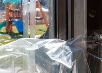DIY Winterizing a glass door by applying thermal plastic with tape and heat shrinking it