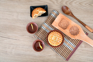Moon cakes and wooden moon cake molds for the Mid-Autumn Festival and two cups of tea