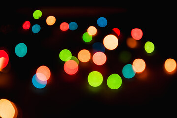 Blurred background. Bright christmas background. Plenty of sparkling bokeh from defocused garland lights. Defocused image.