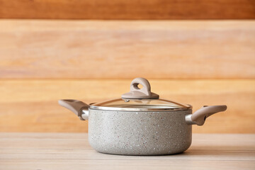 Cooking pot on table against wooden background