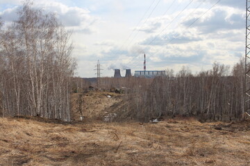 hills in the forest with a high iron electric tower power lines for high-voltage wires in CHP...