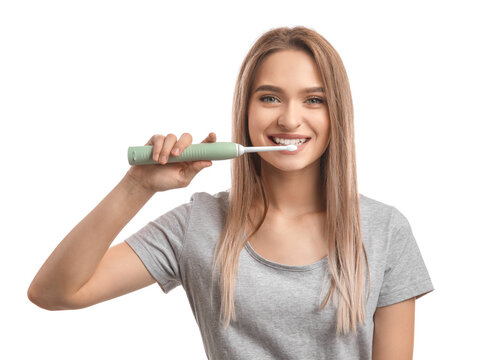 Young Woman With Electric Tooth Brush On White Background