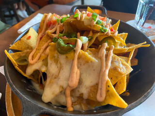 Cheese nachos in black bowl