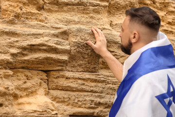 Man with the flag of Israel near the Wailing Wall