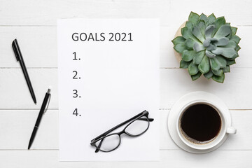 Empty to do list on 2021 year with cup of coffee on white wooden background