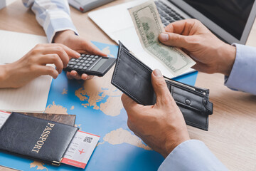 Travel agent receiving money from client for provided service in office