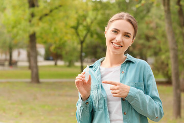Young allergic woman with nasal drops outdoors