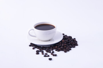 Coffee cup and coffee beans on wooden table.