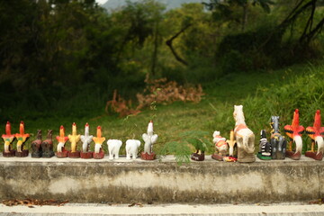 group of animal standing on the side road