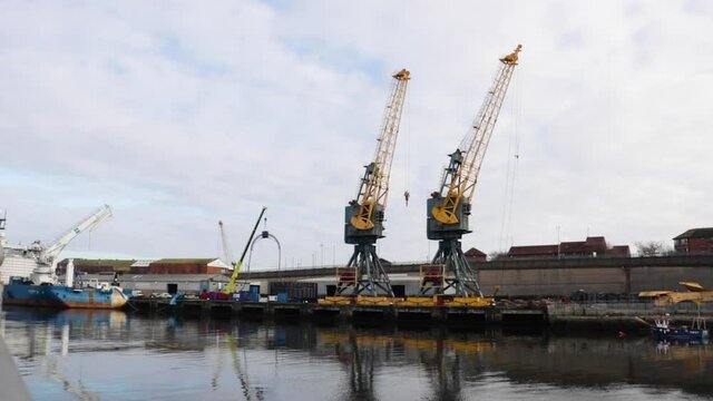 2 Large yellow dock cranes on the River Wear in Sunderland, England. Still shot.