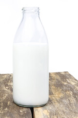A bottle of milk on a wooden background. Copy sapce. Place for text