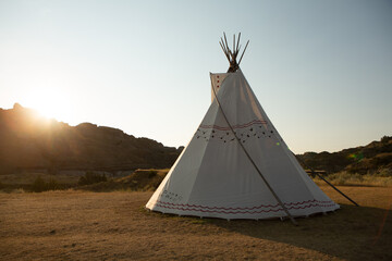 Camping in a Native American Tee-Pee surrounded by the mountains during the sunset
