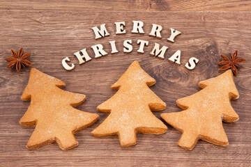 Inscription Merry Christmas with homemade gingerbreads and cookies for festive time