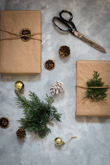 Christmas gifts with Christmas decoration and green tree. Light background. 