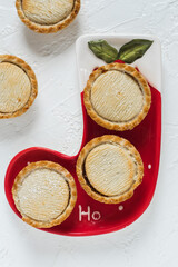 Mince pie on Christmas plat and light background.