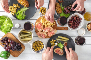 Top view of group of people having dinner together. Dinner with friends concept