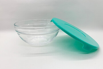 Glass container with green lid isolated with white background