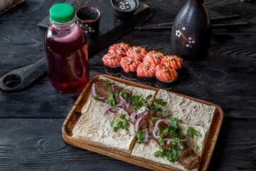 Set of beef kebab with onions and herbs, berry juice and baked rolls with cream cheese cap