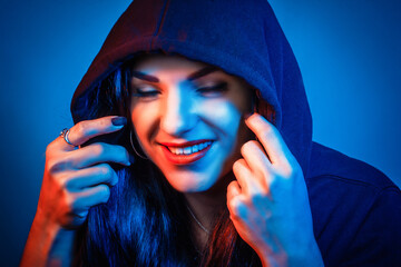 Portrait of a young woman in the Studio in colored red and blue light