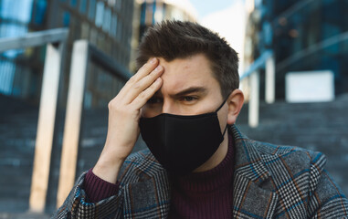 Job loss and unemployment during coronavirus epidemic. Young businessman holding his head and...