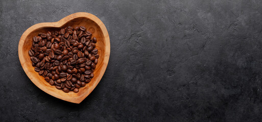 Roasted coffee beans in heart shaped bowl