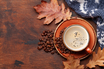 Coffee cup and autumn leaves