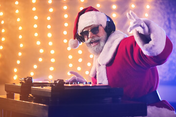 Cool Santa DJ playing music in club