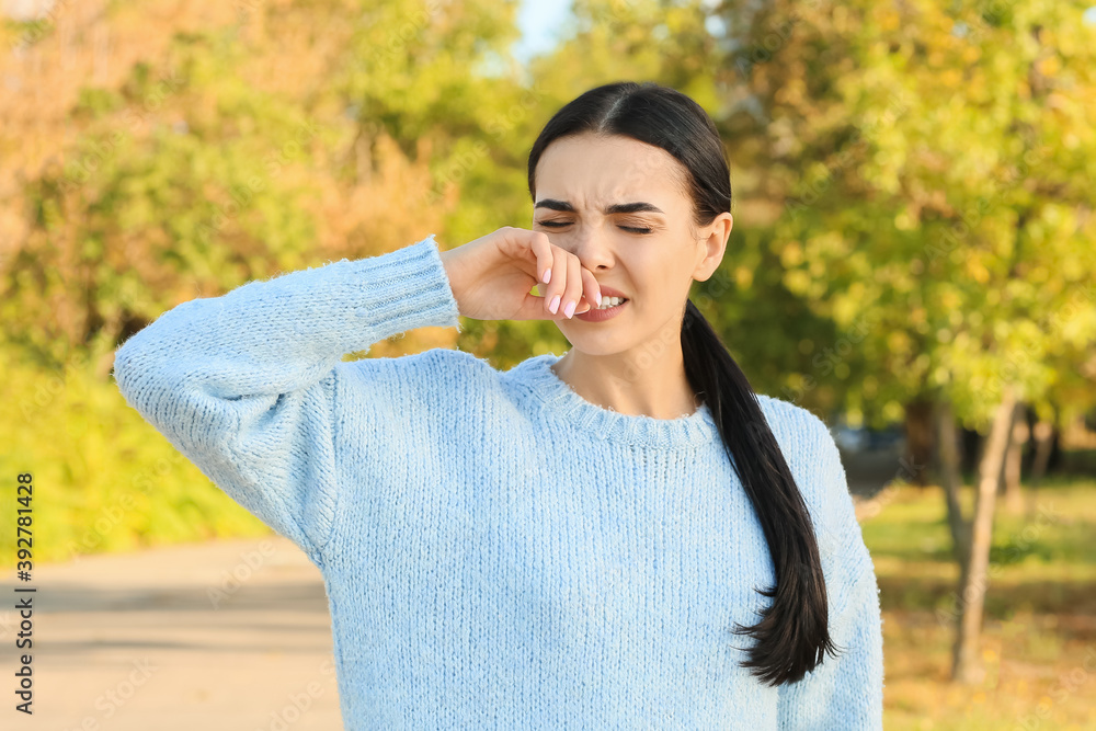 Wall mural Young woman suffering from allergy outdoors