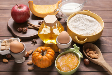 Ingredients for preparing pumpkin pie on wooden background