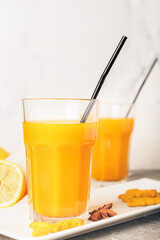 Glass of healthy turmeric drink on table