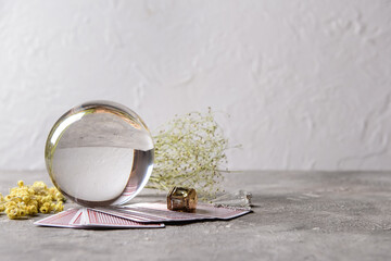 Crystal ball of fortune teller, cards and dry herbs on table - obrazy, fototapety, plakaty
