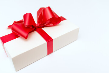 Cristmas white gift box present red bow white background.