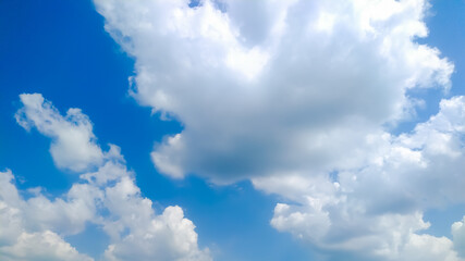 Naklejka na ściany i meble Huge cumulus clouds in blue sky flowing with wind