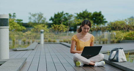 Fototapeta premium Woman work on laptop computer at park