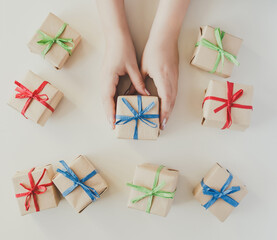 Top view on woman hands holding small gift box - 392786489