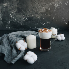 Warm knitted sweater,cup of hot coffee and candle on dark backdrop - 392786620
