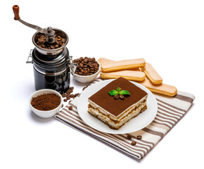Traditional Italian Tiramisu dessert square portion on ceramic plate, coffee mill grinder and savoiardi cookies a isolated on white background with clipping path