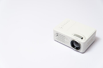 close up of a white little projector on white background 