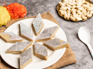 Kaju katli / kaju barfi is a diamond shape indian sweet made with using cashew stock image. 